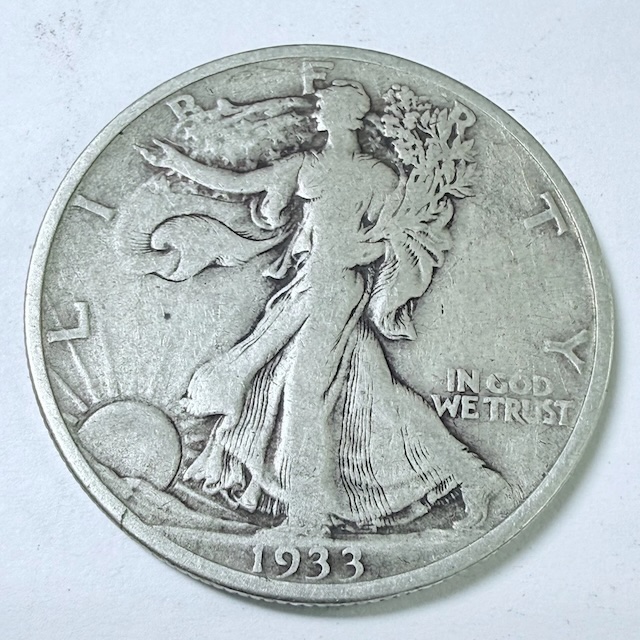 Walking Liberty Half Dollar off-center strike showing offset design with blank planchet crescent